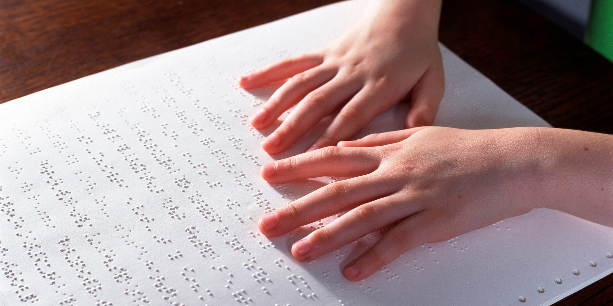 child reading braille